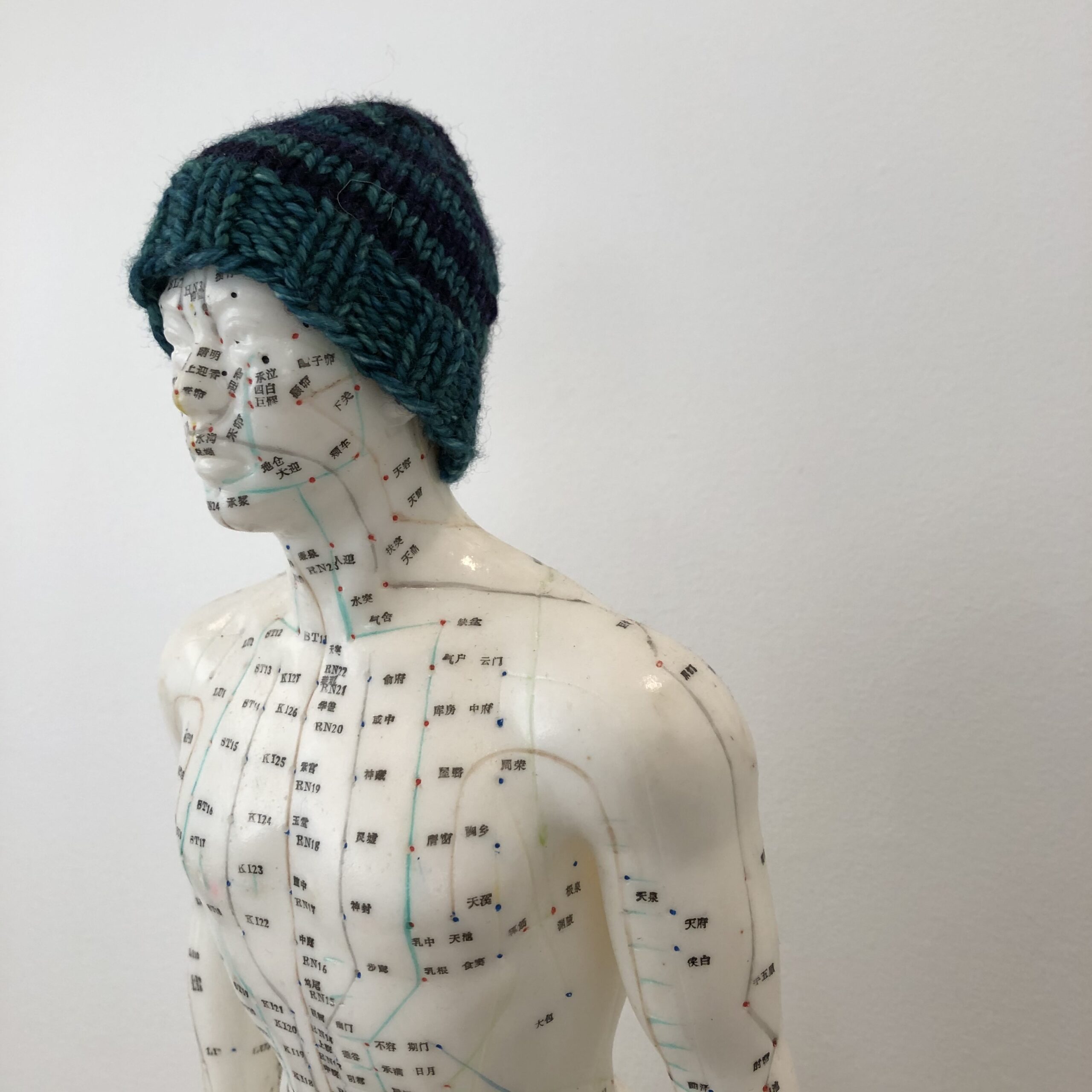 Meridian man showing acupuncture points with touque