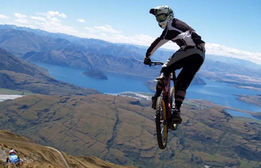 Mountain biker looking back in the air off a jump